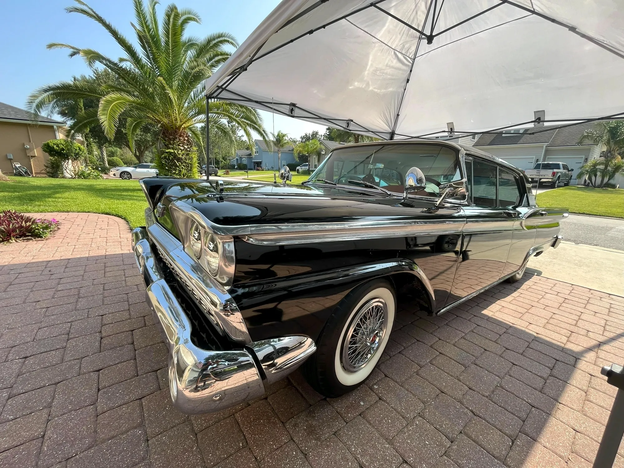 A 1959 Ford detailed to a mirror black finish on a paver driveway in Ponte Vedra, Florida