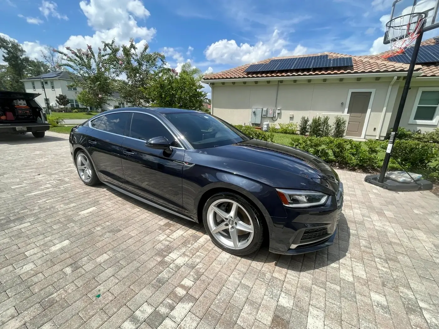 Black Audi S5 detailed on a paver driveway
